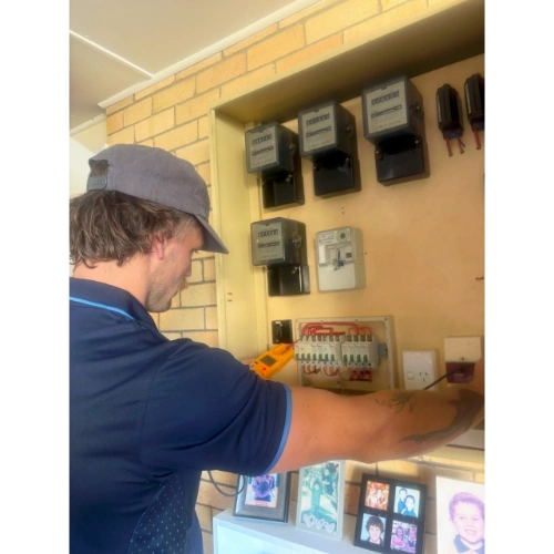 Wave Energy Co electrician working on a switchboard